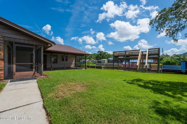 a front view of a house with a yard and trees