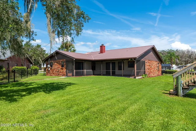 a view of a lake with a house in the background