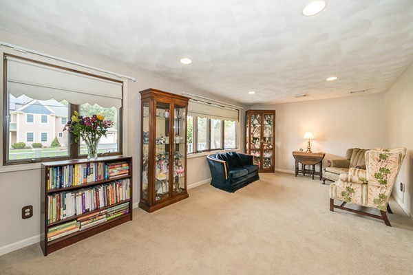 10 Scotland Road Lexington, MA 02420 - Photo 15 of 24 a living room with furniture and a book shelf