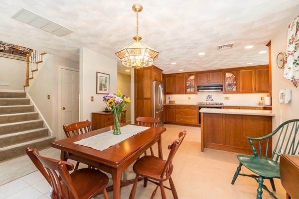 10 Scotland Road Lexington, MA 02420 - Photo 9 of 24 a view of a dining room with furniture a chandelier and wooden floor