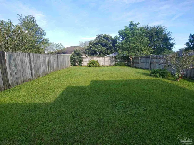 a view of a backyard with a garden and trees