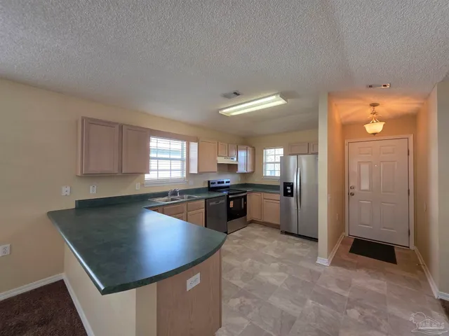 a kitchen with a sink a counter top space and appliances
