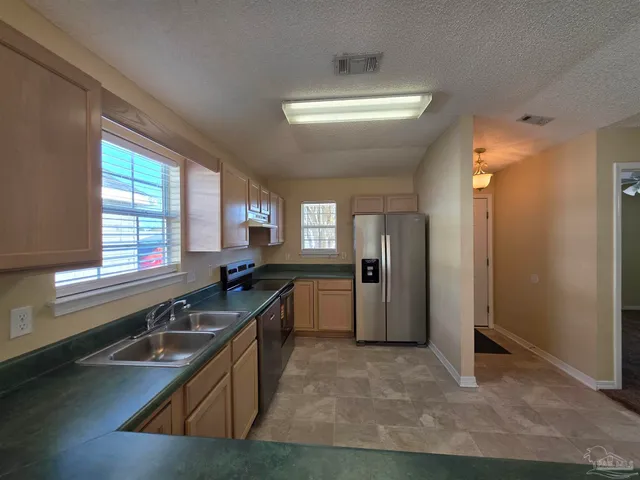 a kitchen with a sink and a large window