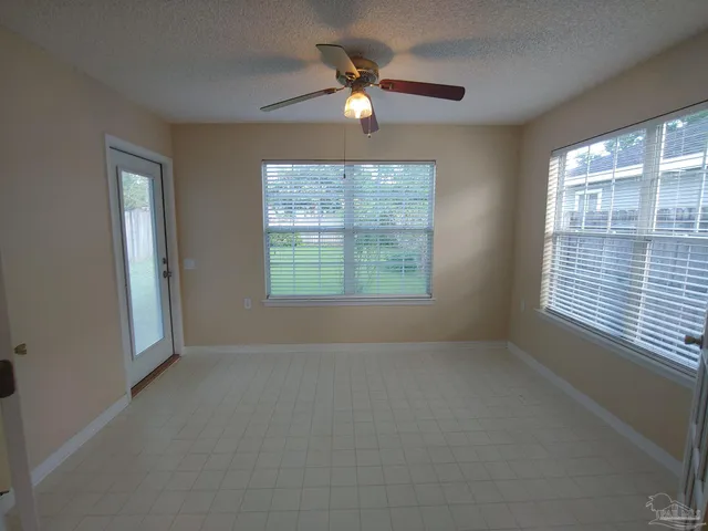 a view of a livingroom with a ceiling fan and window