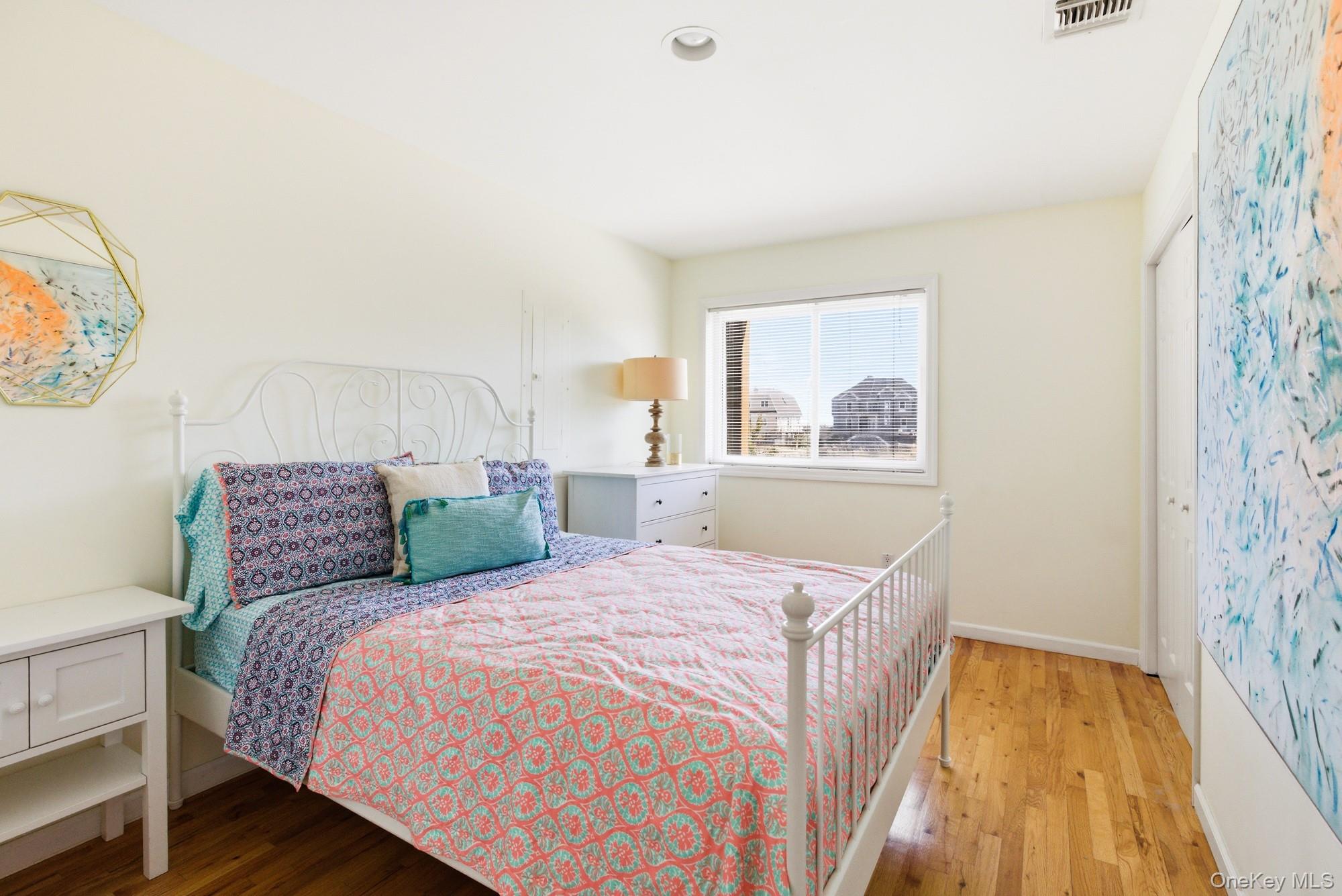 818 Dune Road Westhampton Beach, NY 11978 - Photo 13 of 30 a bedroom with a bed and a window
