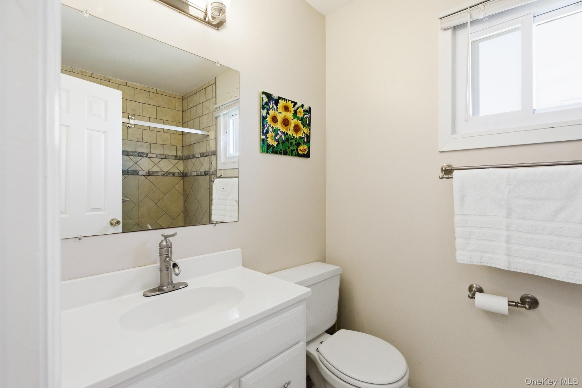 818 Dune Road Westhampton Beach, NY 11978 - Photo 15 of 30 a bathroom with a sink mirror vanity and toilet