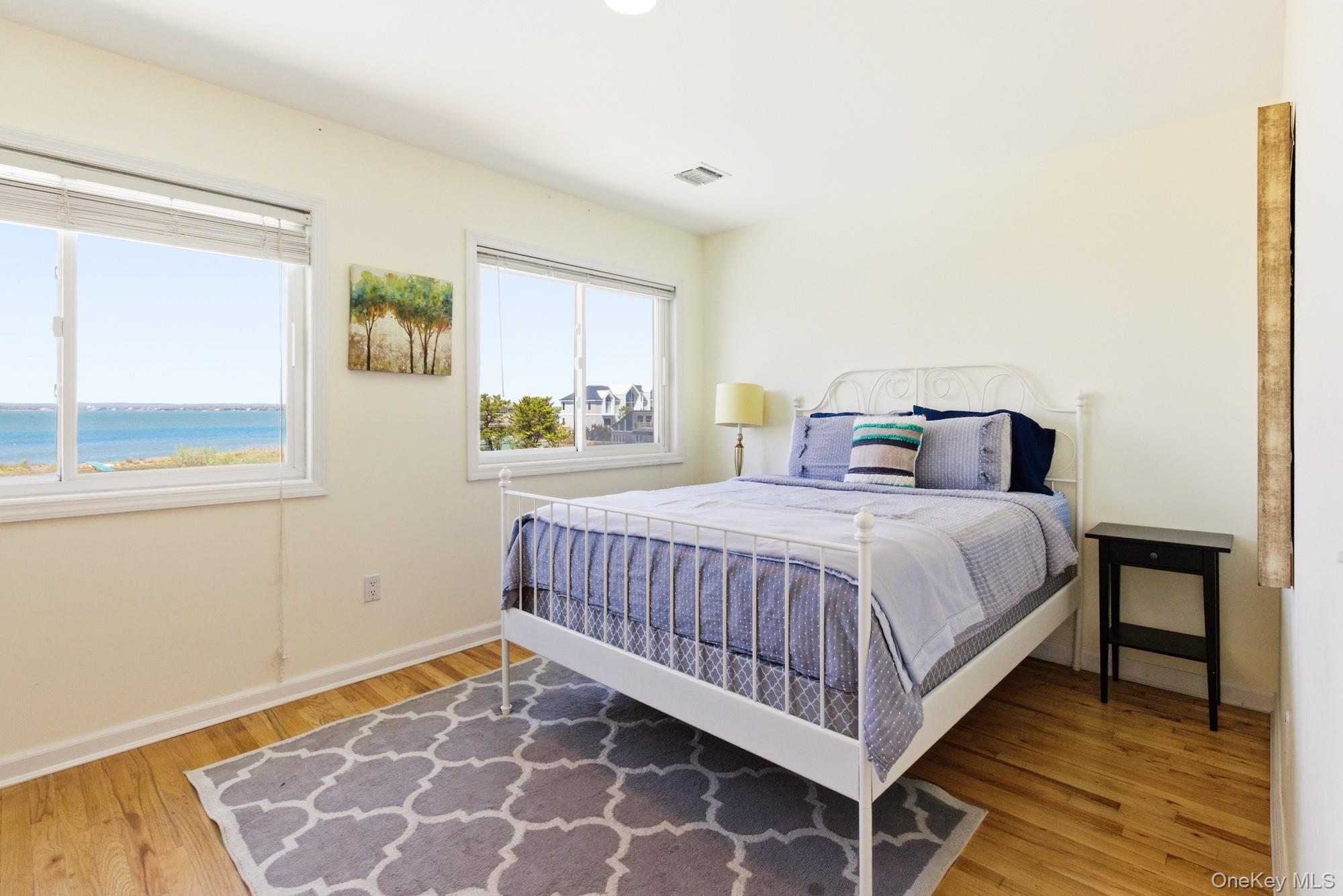 818 Dune Road Westhampton Beach, NY 11978 - Photo 17 of 30 a bedroom with a bed and a window