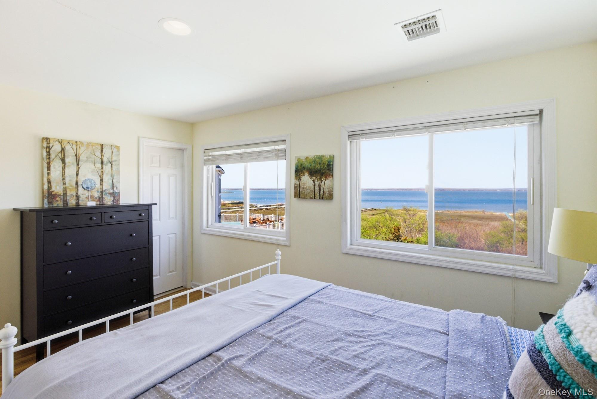 818 Dune Road Westhampton Beach, NY 11978 - Photo 18 of 30 a bedroom with a bed and a window