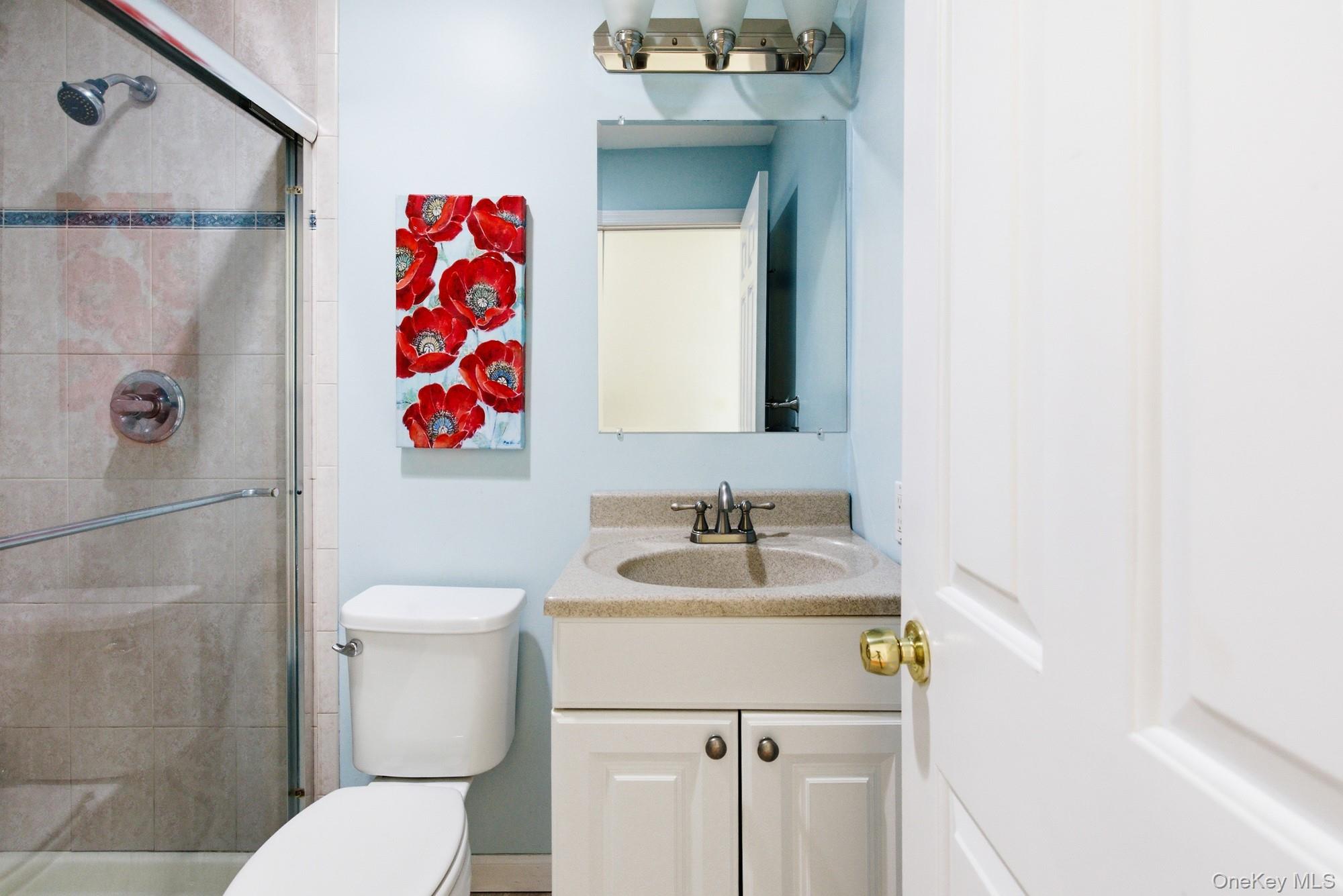 818 Dune Road Westhampton Beach, NY 11978 - Photo 22 of 30 a bathroom with a sink and a mirror