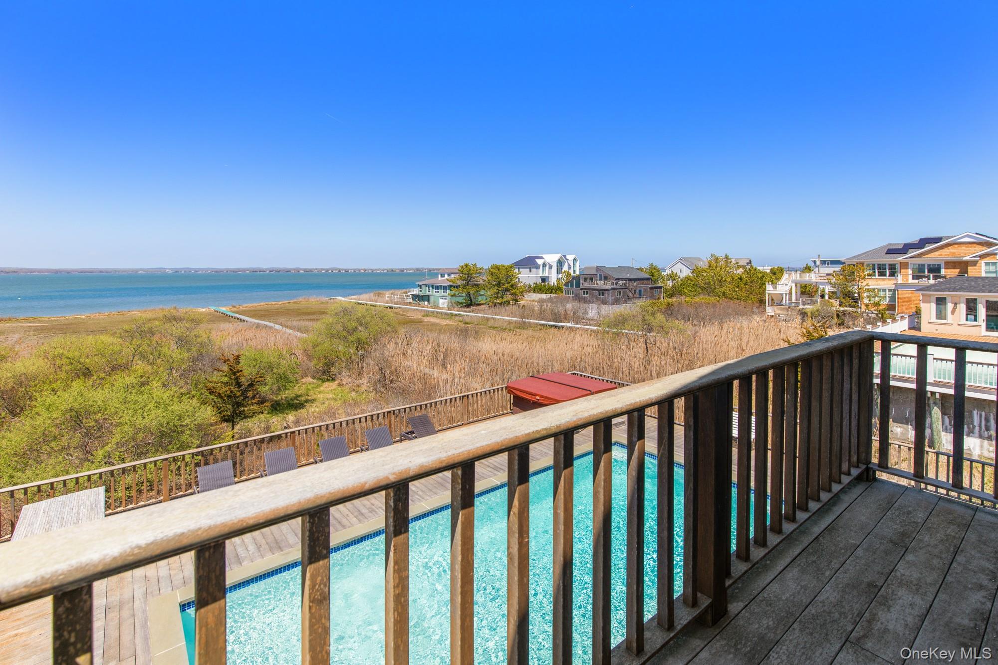 818 Dune Road Westhampton Beach, NY 11978 - Photo 28 of 30 a view of city and ocean from a balcony