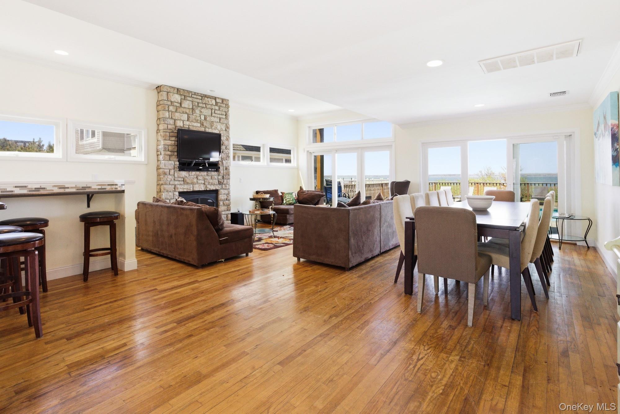 818 Dune Road Westhampton Beach, NY 11978 - Photo 5 of 30 a living room with fireplace furniture and a flat screen tv