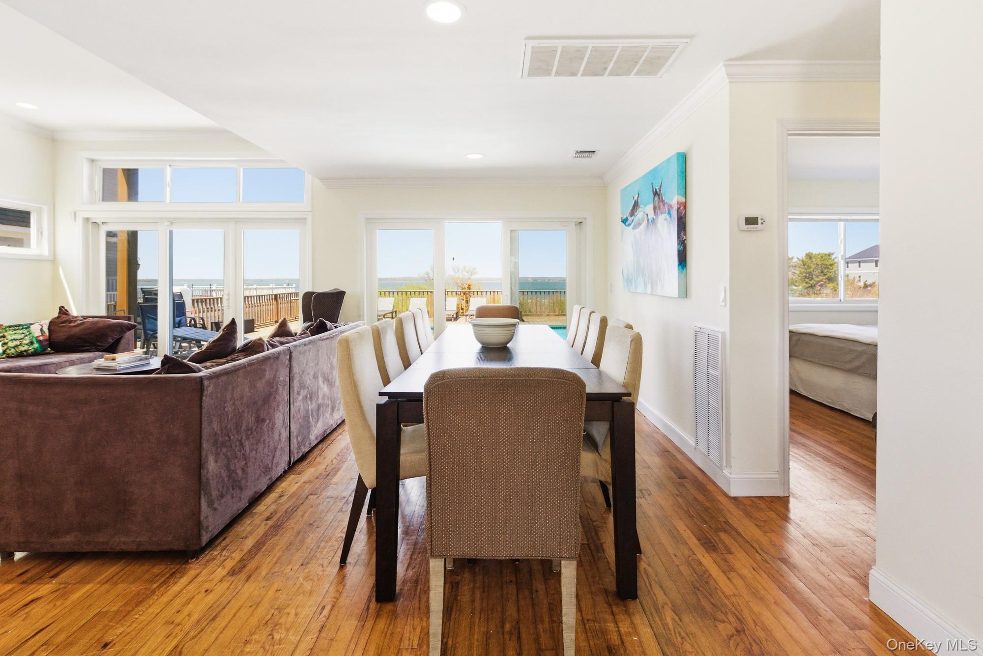 818 Dune Road Westhampton Beach, NY 11978 - Photo 6 of 30 a dining room with furniture and wooden floor