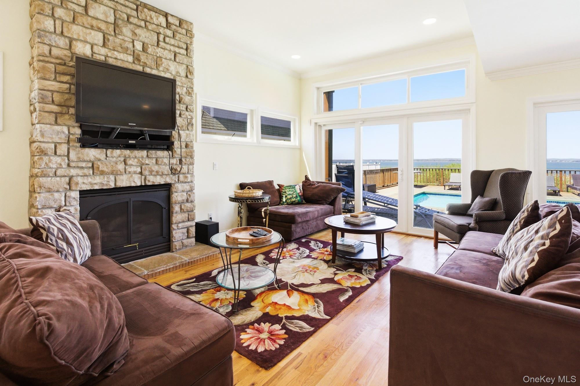818 Dune Road Westhampton Beach, NY 11978 - Photo 9 of 30 a living room with fireplace furniture and a flat screen tv