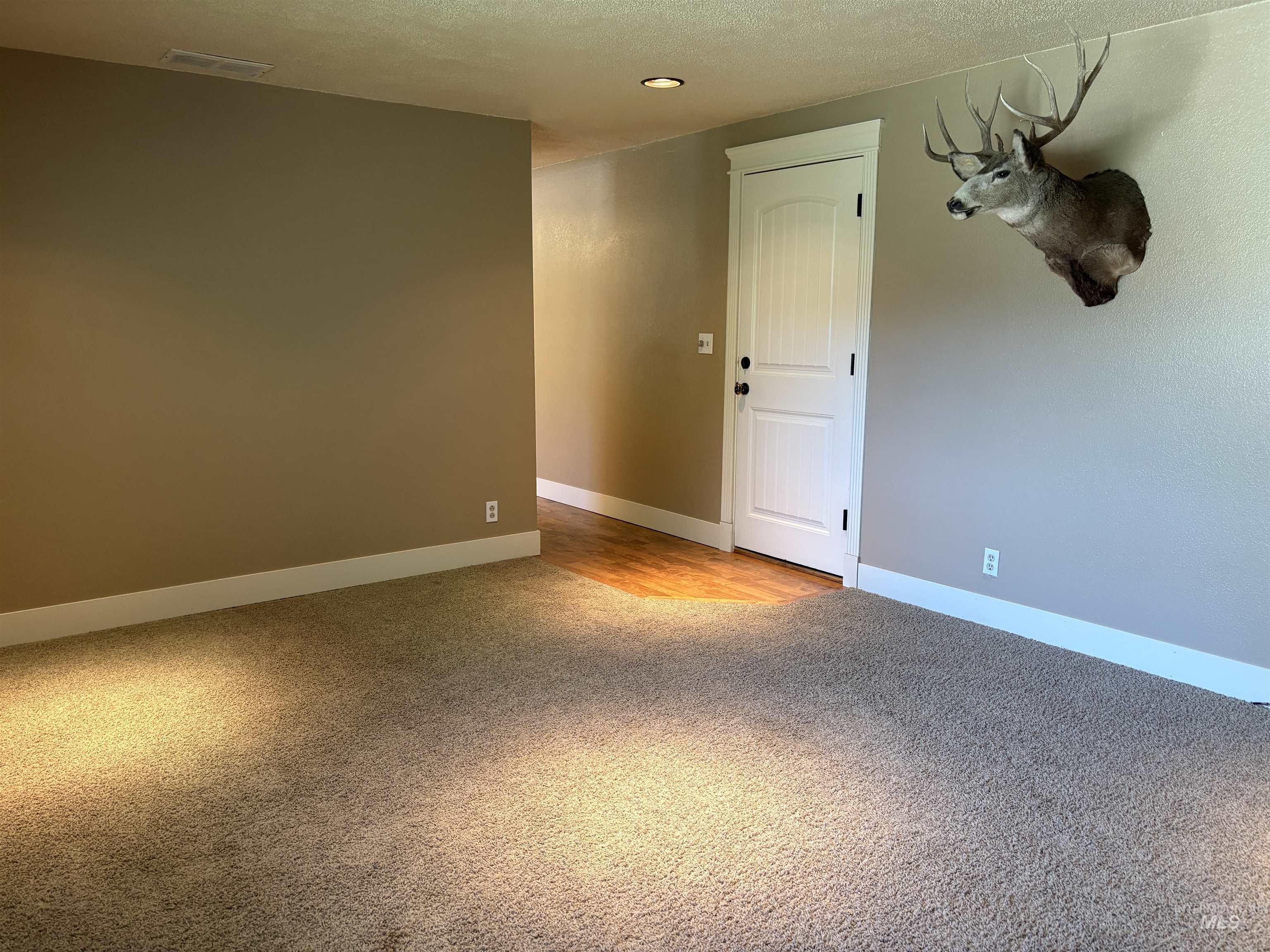 513 Ridge Way Ontario, OR 97914 - Photo 11 of 29 Brick fireplace with a wooden mantel, a metal firebox, and a hearth