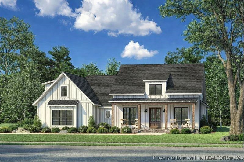 115 Keyser Street Aberdeen, NC 28315 - Photo 1 of 17 a front view of a house with a garden and trees