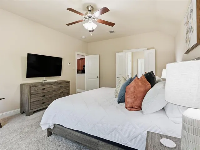 a bedroom with a bed and a flat screen tv