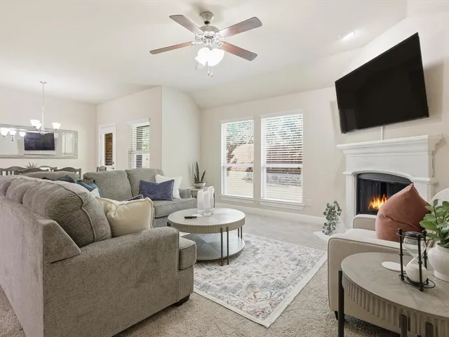 a living room with furniture a fireplace and a flat screen tv