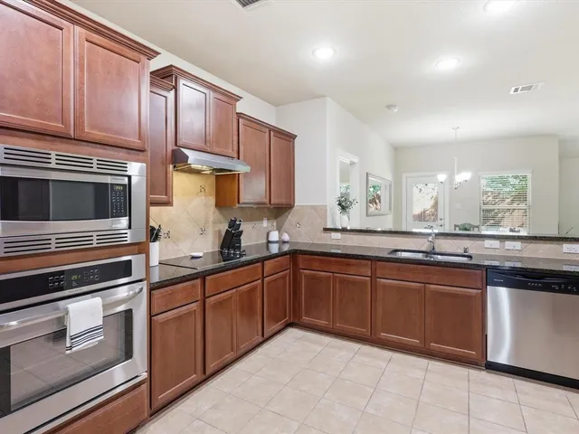a kitchen with sink and cabinets