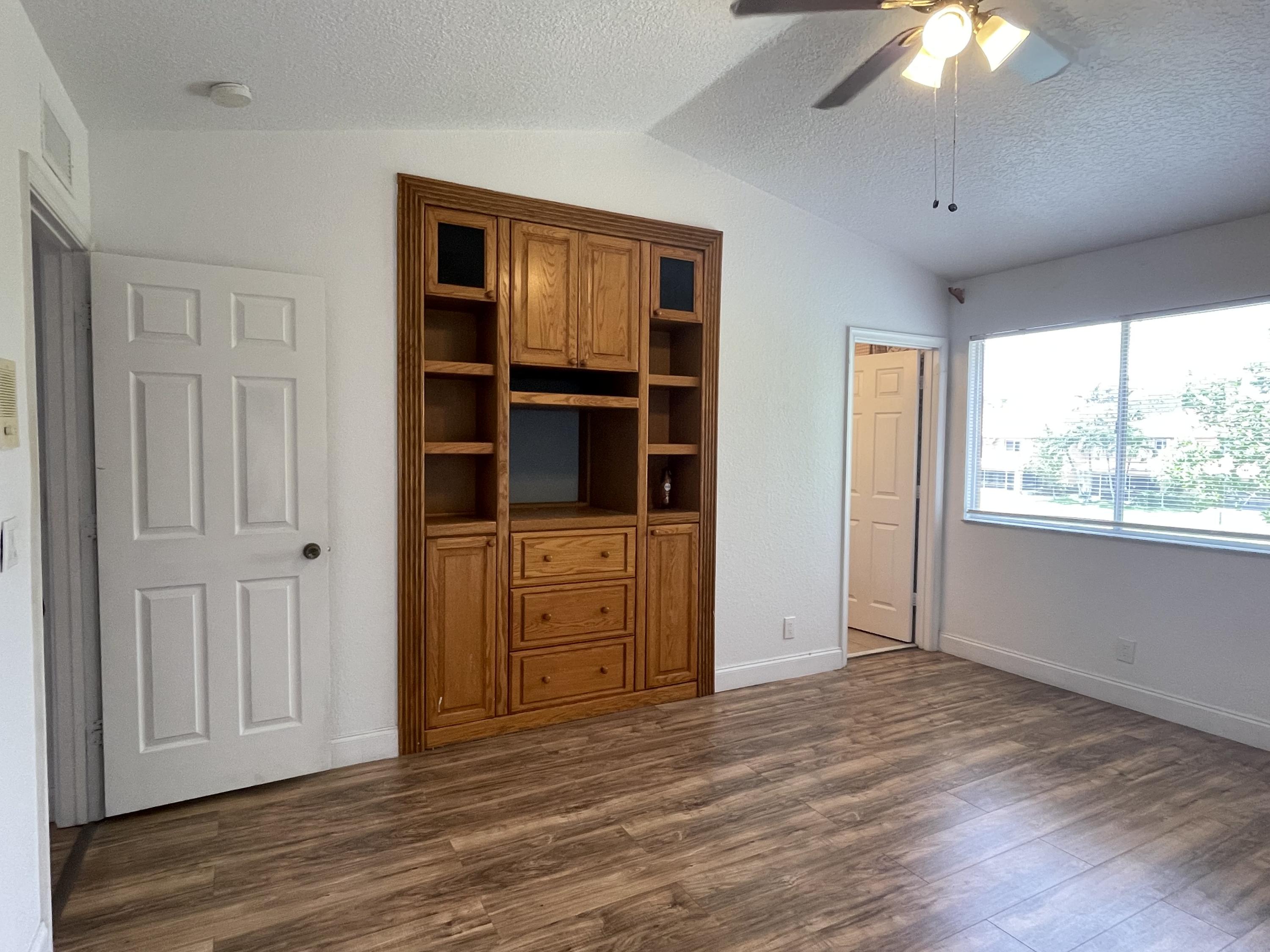 6204 Sandy Bank Terrace West Palm Beach, FL 33407 - Photo 15 of 37 a view of empty room with window and wooden floor