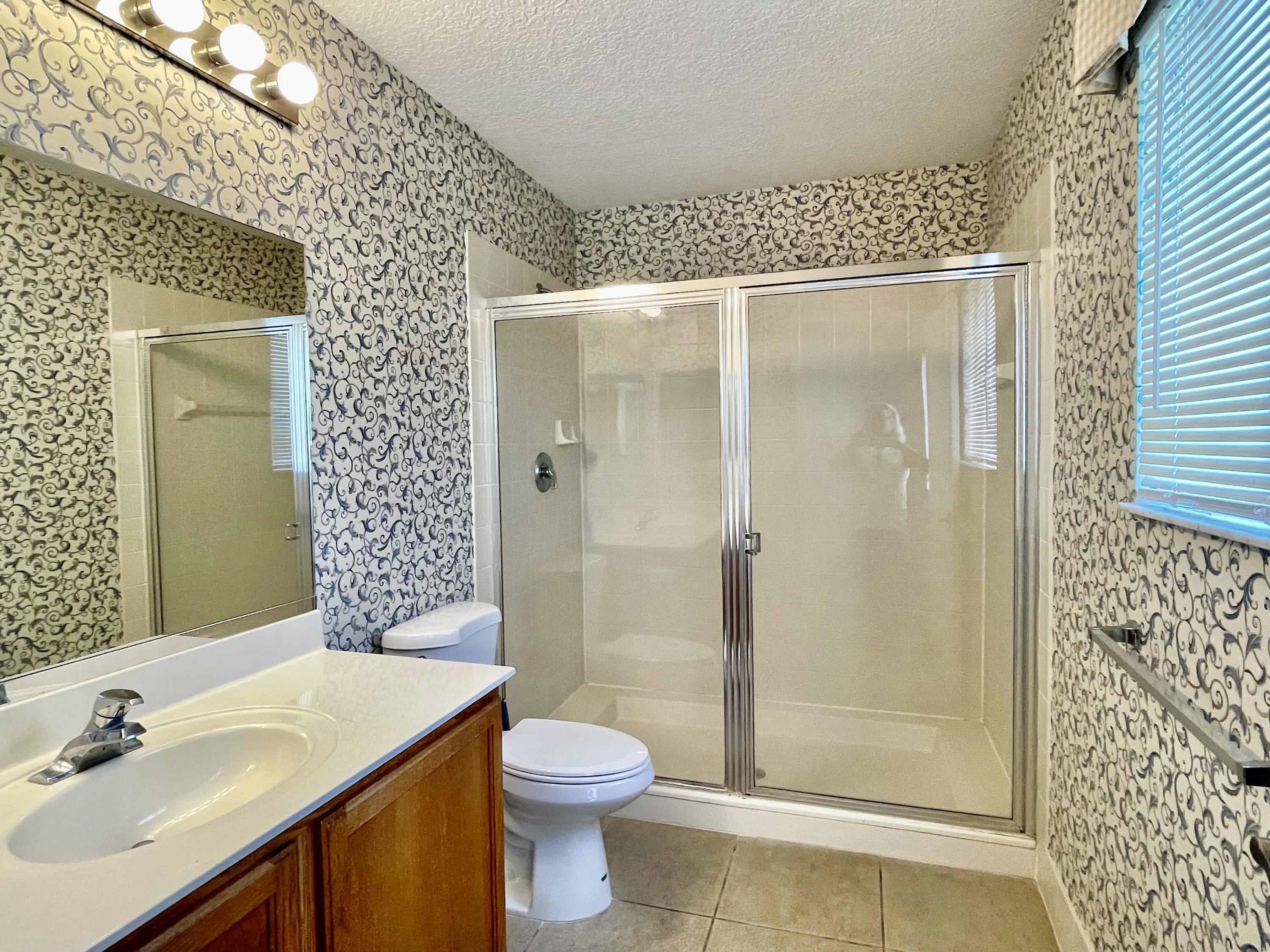 6204 Sandy Bank Terrace West Palm Beach, FL 33407 - Photo 17 of 37 a bathroom with a shower and a sink