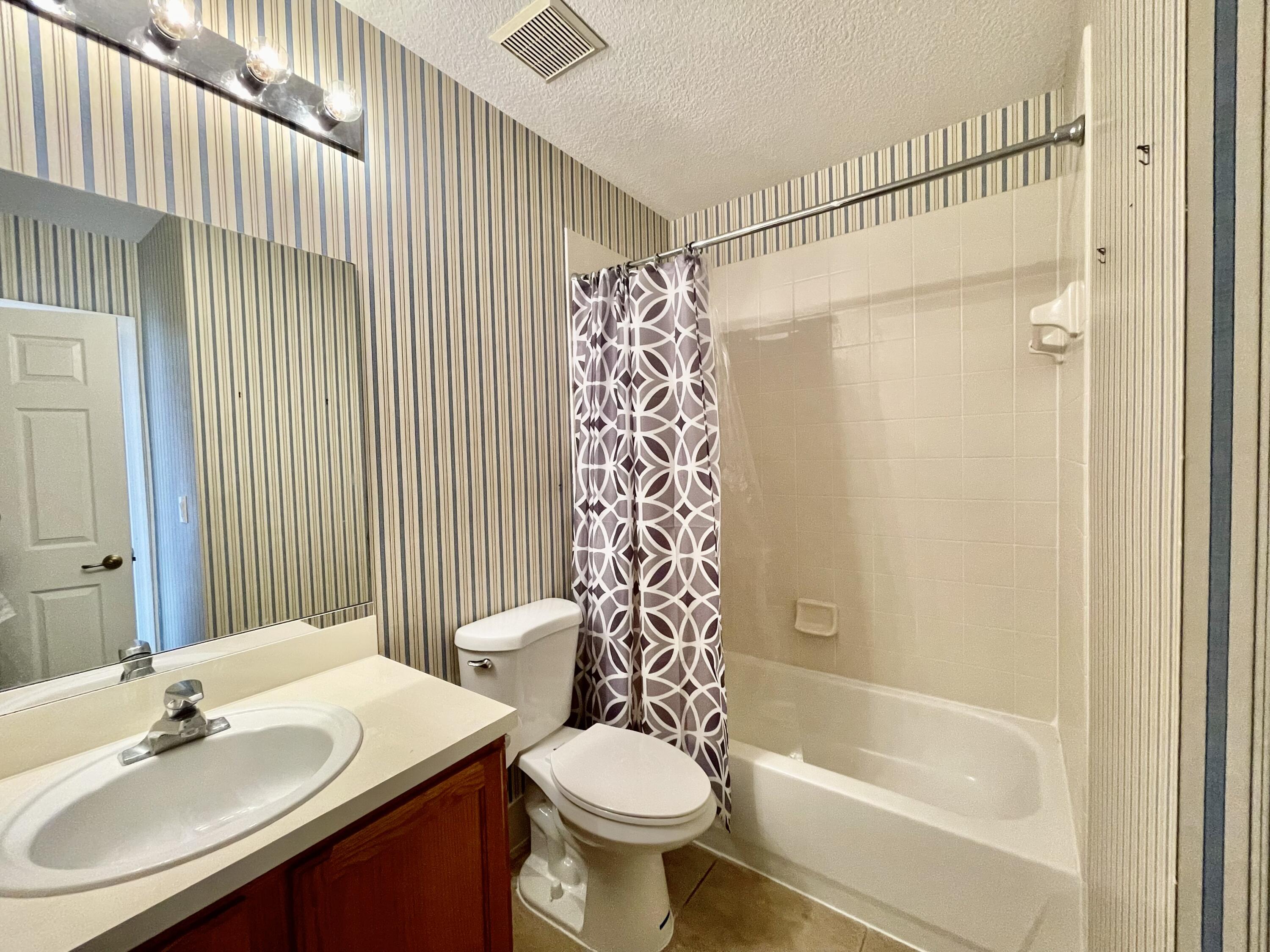 6204 Sandy Bank Terrace West Palm Beach, FL 33407 - Photo 19 of 37 a bathroom with a sink a toilet and shower