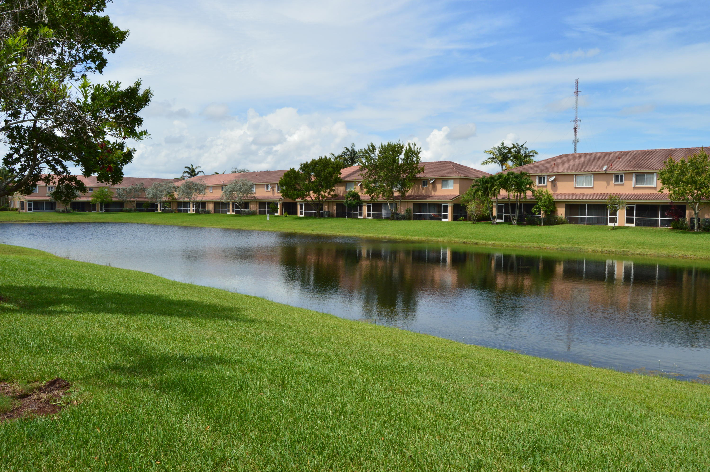 6204 Sandy Bank Terrace West Palm Beach, FL 33407 - Photo 2 of 37 a view of a lake with houses in the background