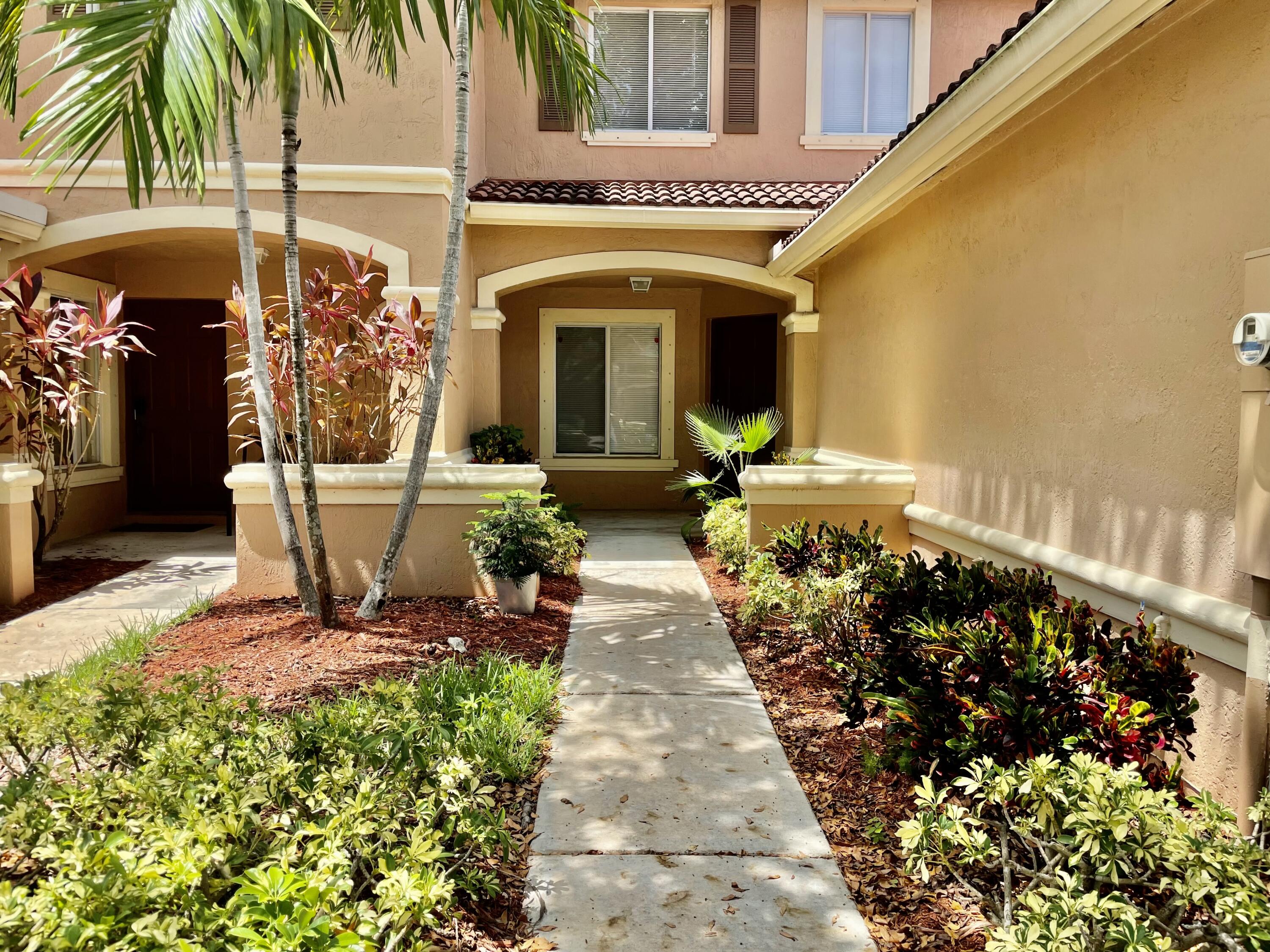 6204 Sandy Bank Terrace West Palm Beach, FL 33407 - Photo 23 of 37 a front view of a house with garden