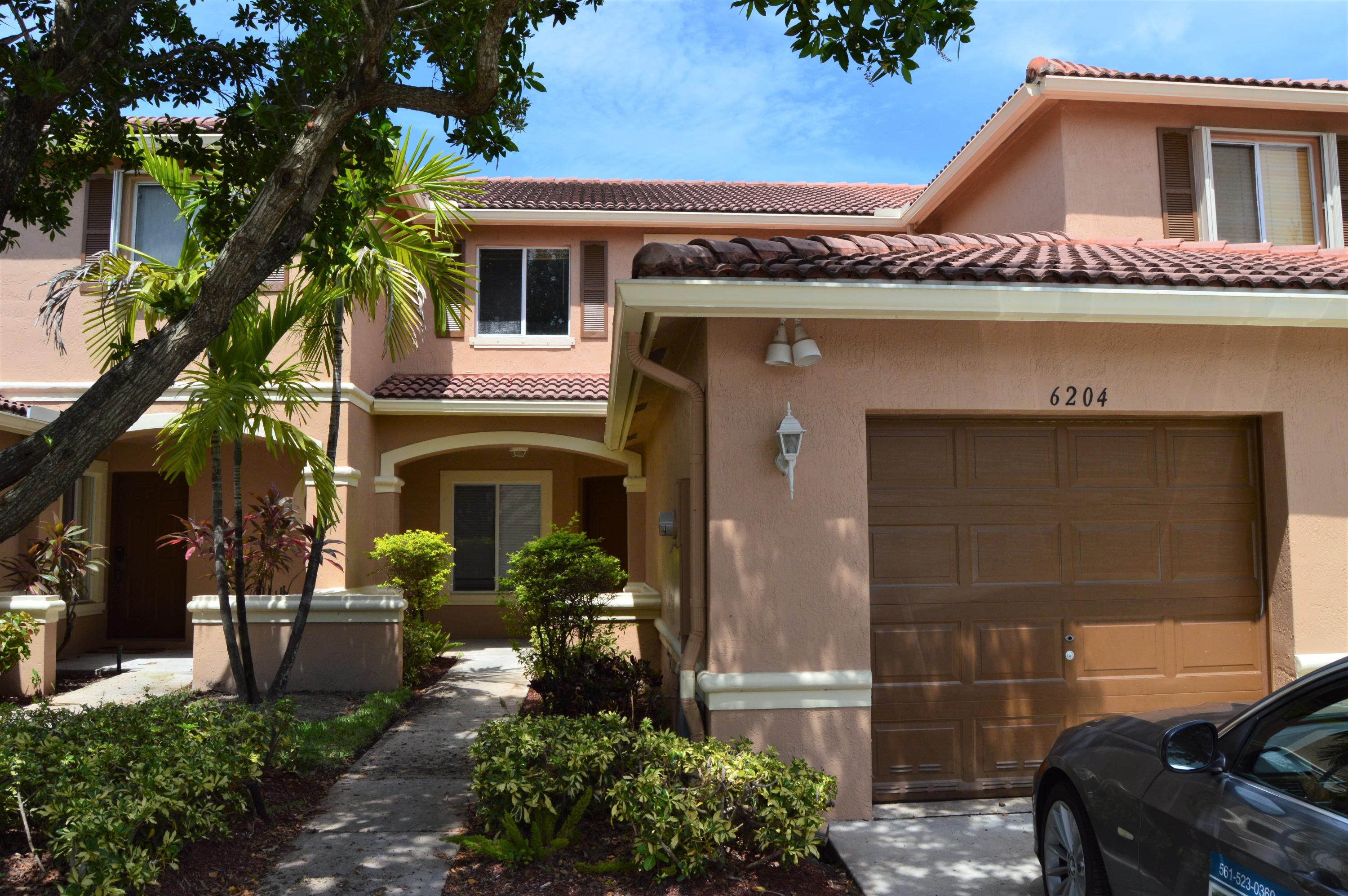 6204 Sandy Bank Terrace West Palm Beach, FL 33407 - Photo 24 of 37 a front view of a house with garden