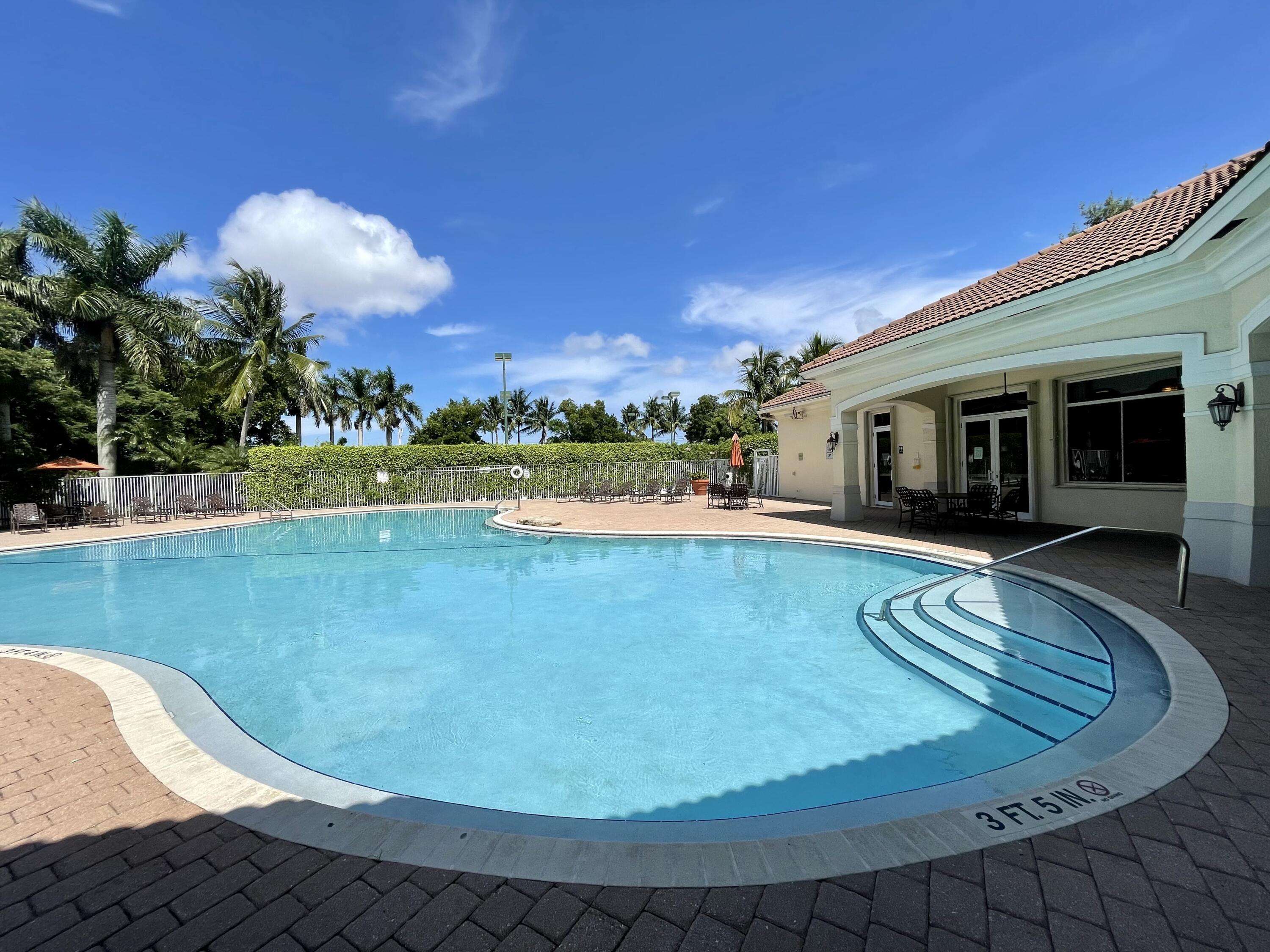 6204 Sandy Bank Terrace West Palm Beach, FL 33407 - Photo 26 of 37 a view of a swimming pool with a yard and plants