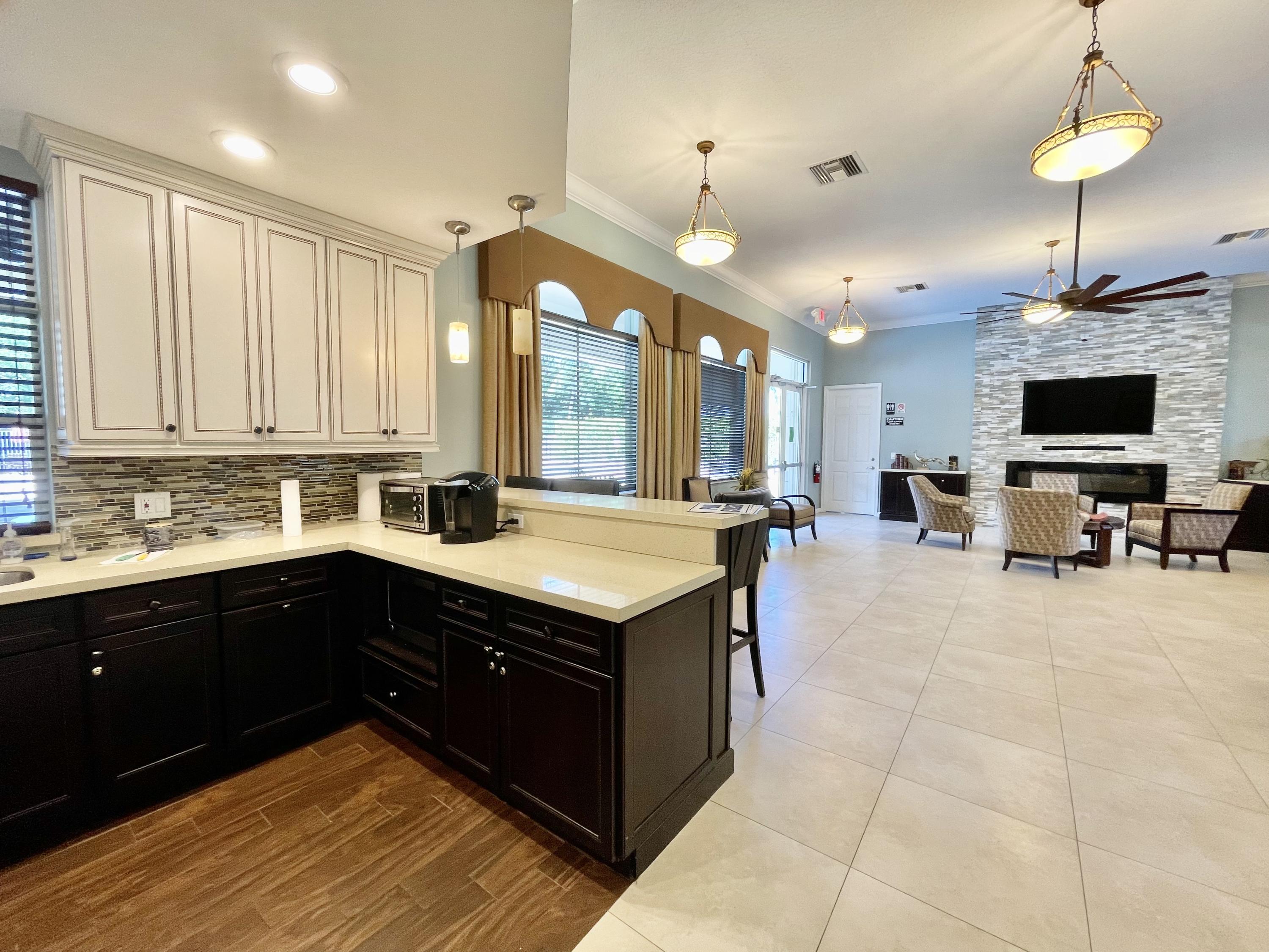 6204 Sandy Bank Terrace West Palm Beach, FL 33407 - Photo 28 of 37 a kitchen with a stove and a sink