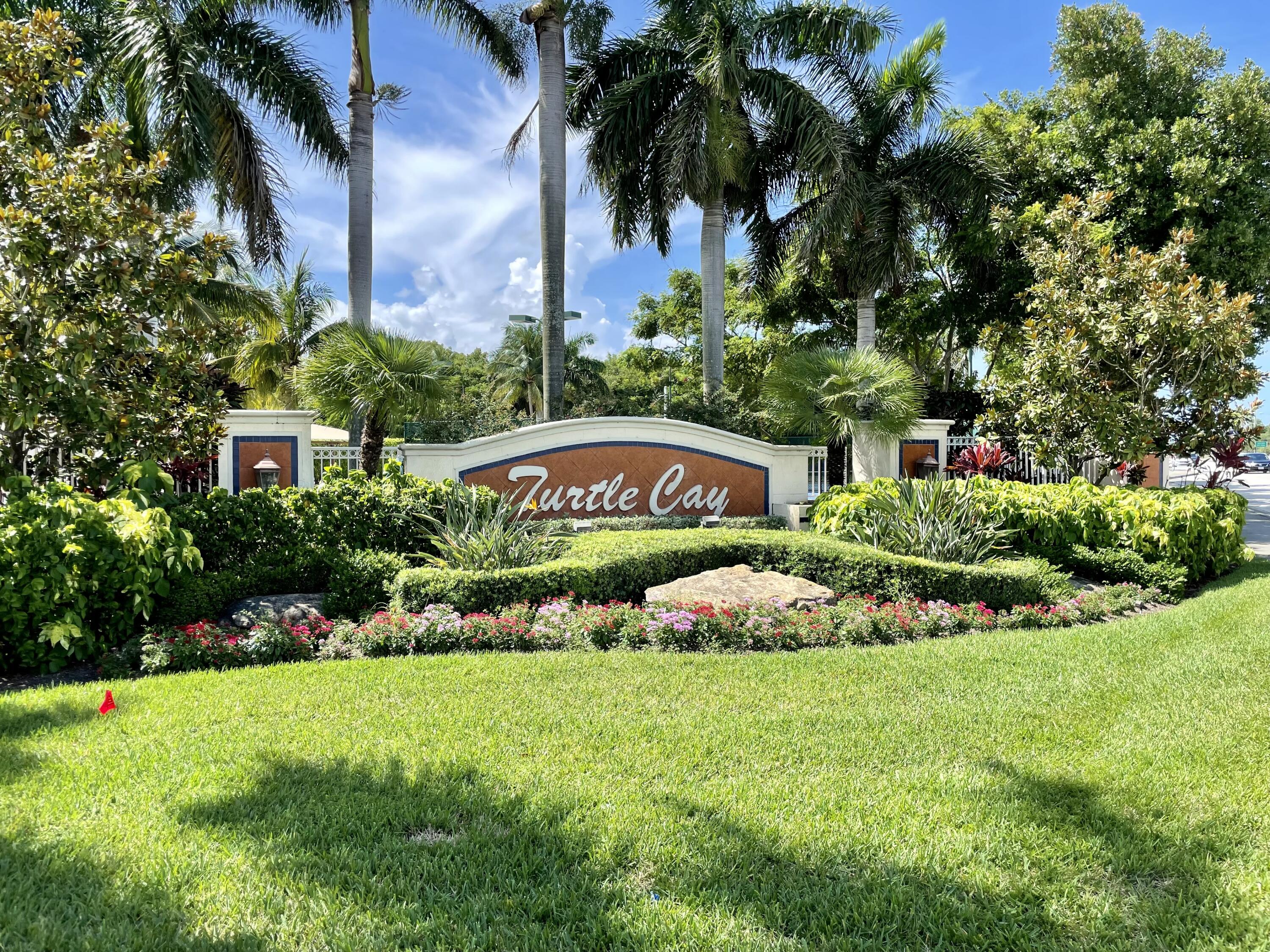 6204 Sandy Bank Terrace West Palm Beach, FL 33407 - Photo 37 of 37 a view of a sign in front of a house with a big yard and potted plants
