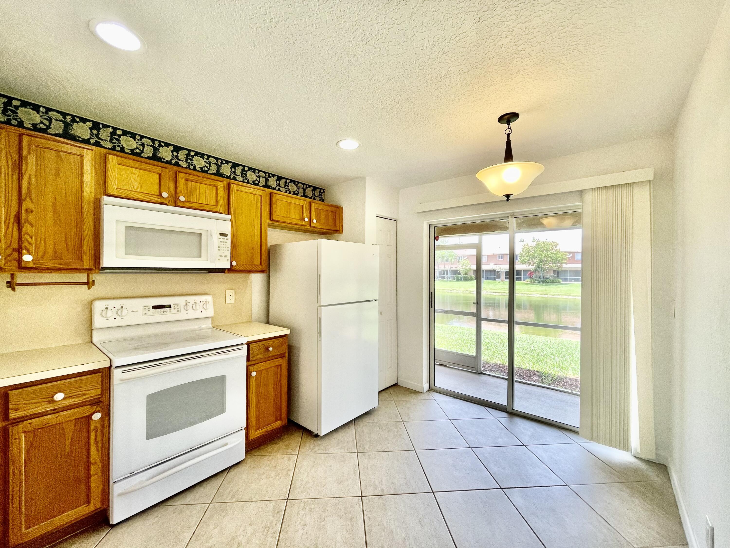 6204 Sandy Bank Terrace West Palm Beach, FL 33407 - Photo 4 of 37 a kitchen with appliances cabinets and a sink