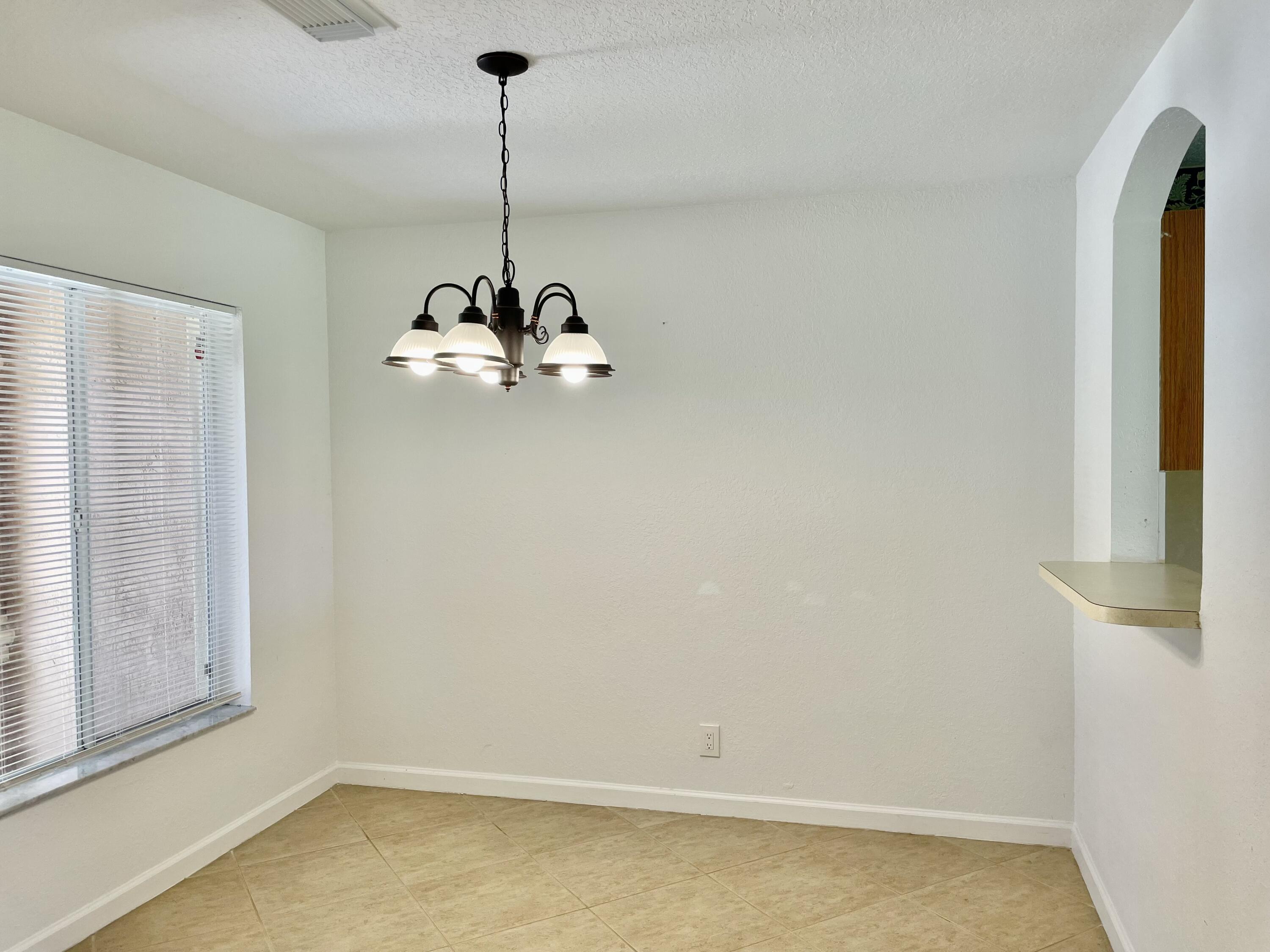 6204 Sandy Bank Terrace West Palm Beach, FL 33407 - Photo 6 of 37 a room with window and ceiling fan