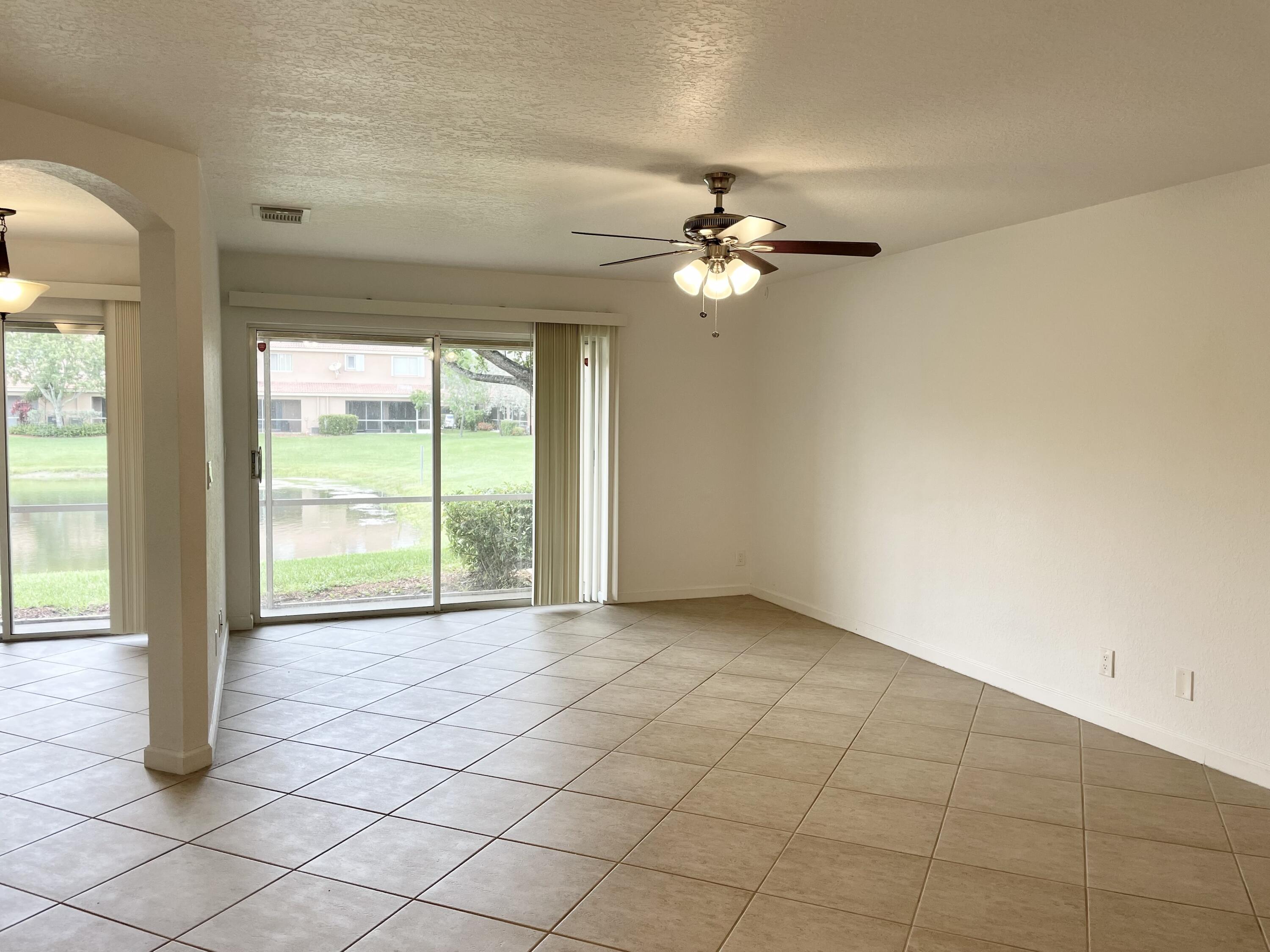 6204 Sandy Bank Terrace West Palm Beach, FL 33407 - Photo 7 of 37 an empty room with windows and fan
