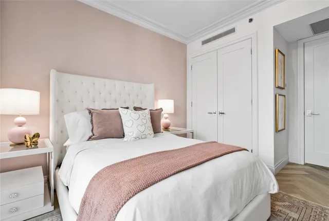 a bedroom with a bed and a lamp