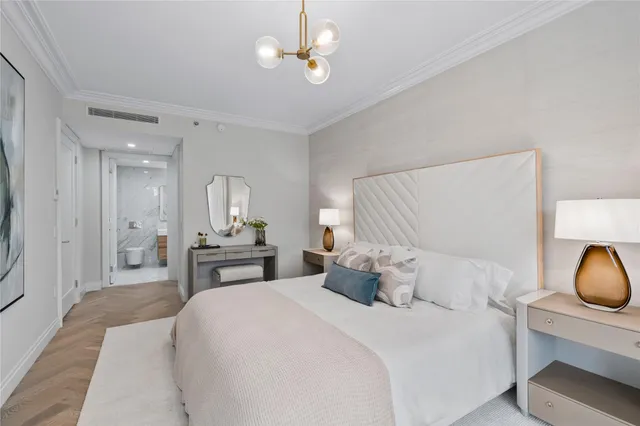 a bedroom with a bed and a chandelier