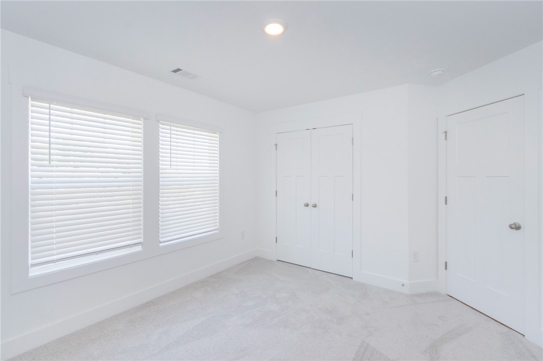 607 WH Kay Lane Anderson, SC 29621 - Photo 24 of 48 White walls and light gray carpet create a pristine canvas in this naturally illuminated space.