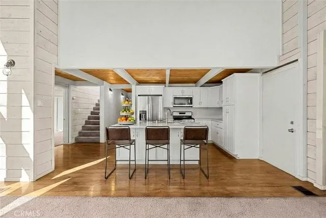 a view of kitchen with furniture and wooden floor