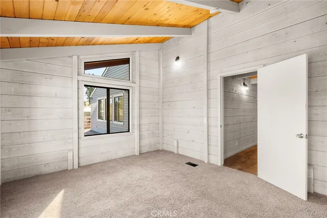 a view of kitchen island with furniture and refrigerator