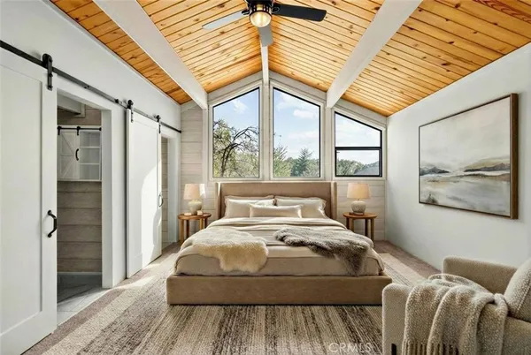 a bedroom with a bed and a large window