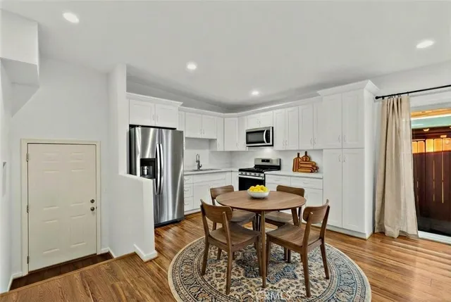 a view of a dining room with furniture and wooden floor