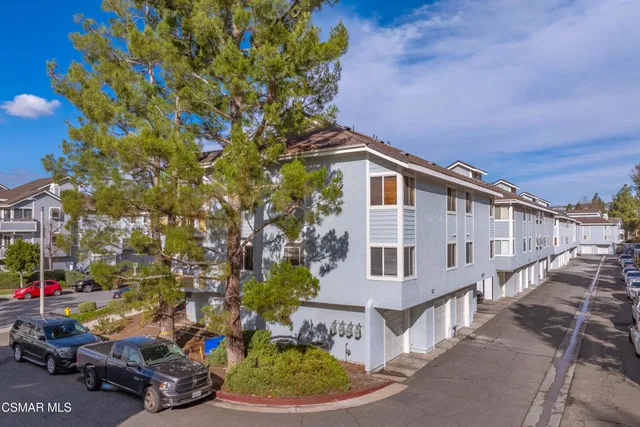 a view of a large building with a tree in the background