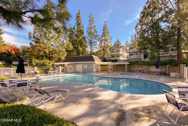 a view of a swimming pool and lounge chairs