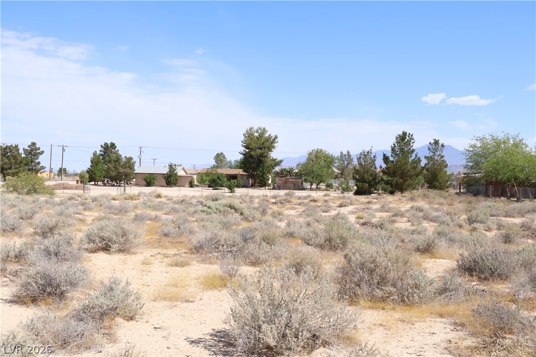 4501 East Kellogg Road Pahrump, NV 89061 - Photo 40 of 52 A spacious desert lot awaits your vision, surrounded by distant mountains and scattered homes.