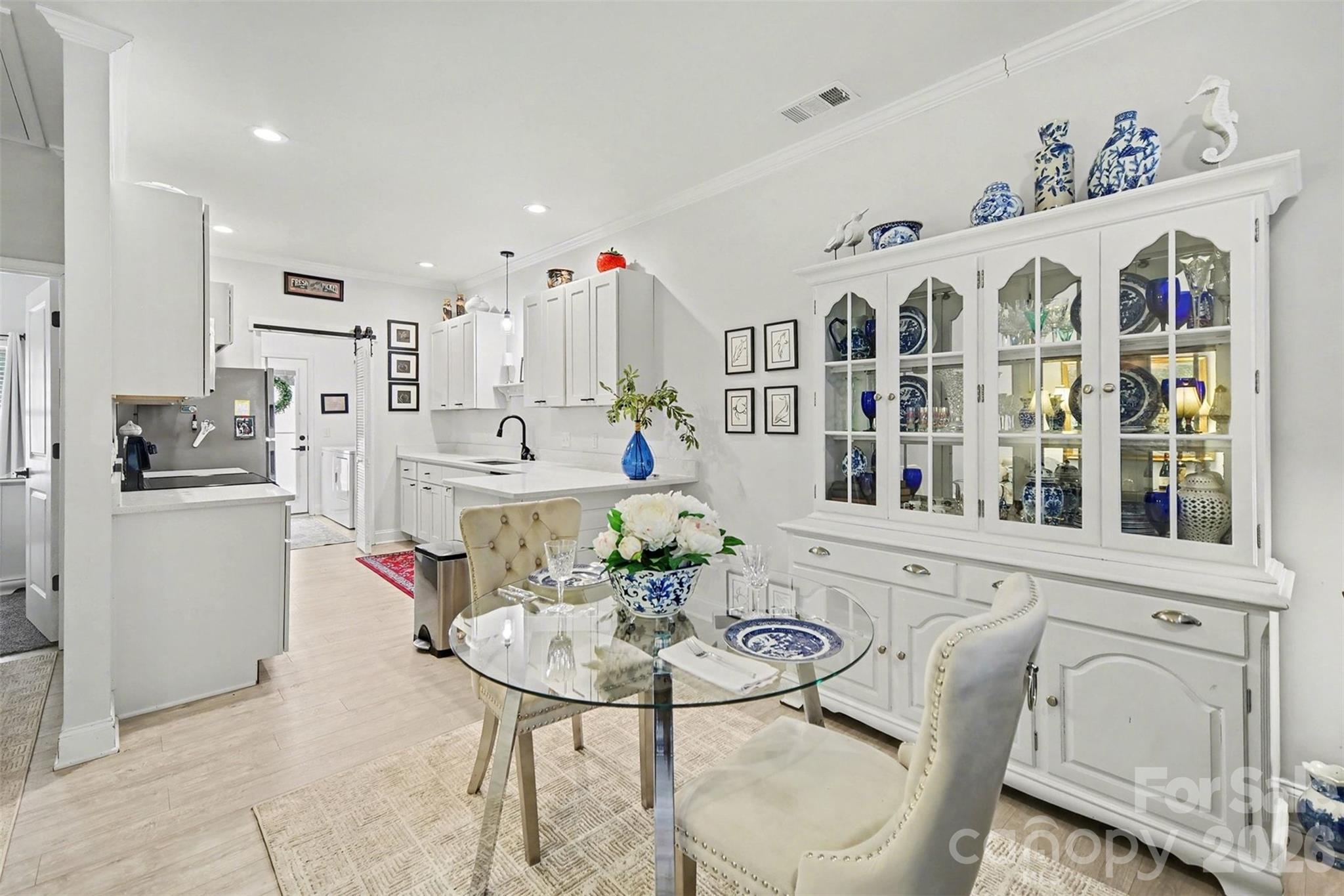 a kitchen with stainless steel appliances kitchen island granite countertop a table and chairs in it