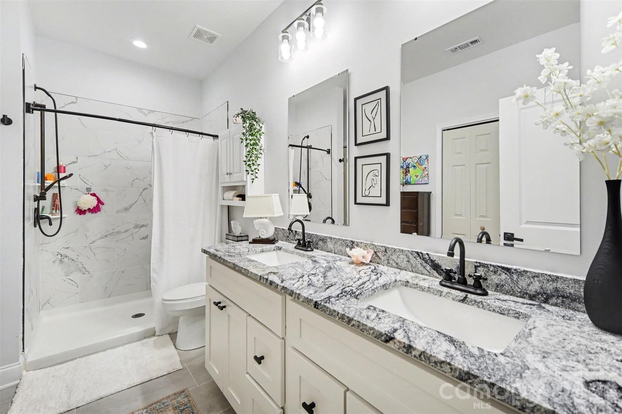 3236 Cottage Rose Lane Rock Hill, SC 29732 - Photo 17 of 27 a bathroom with a granite countertop sink mirror and shower
