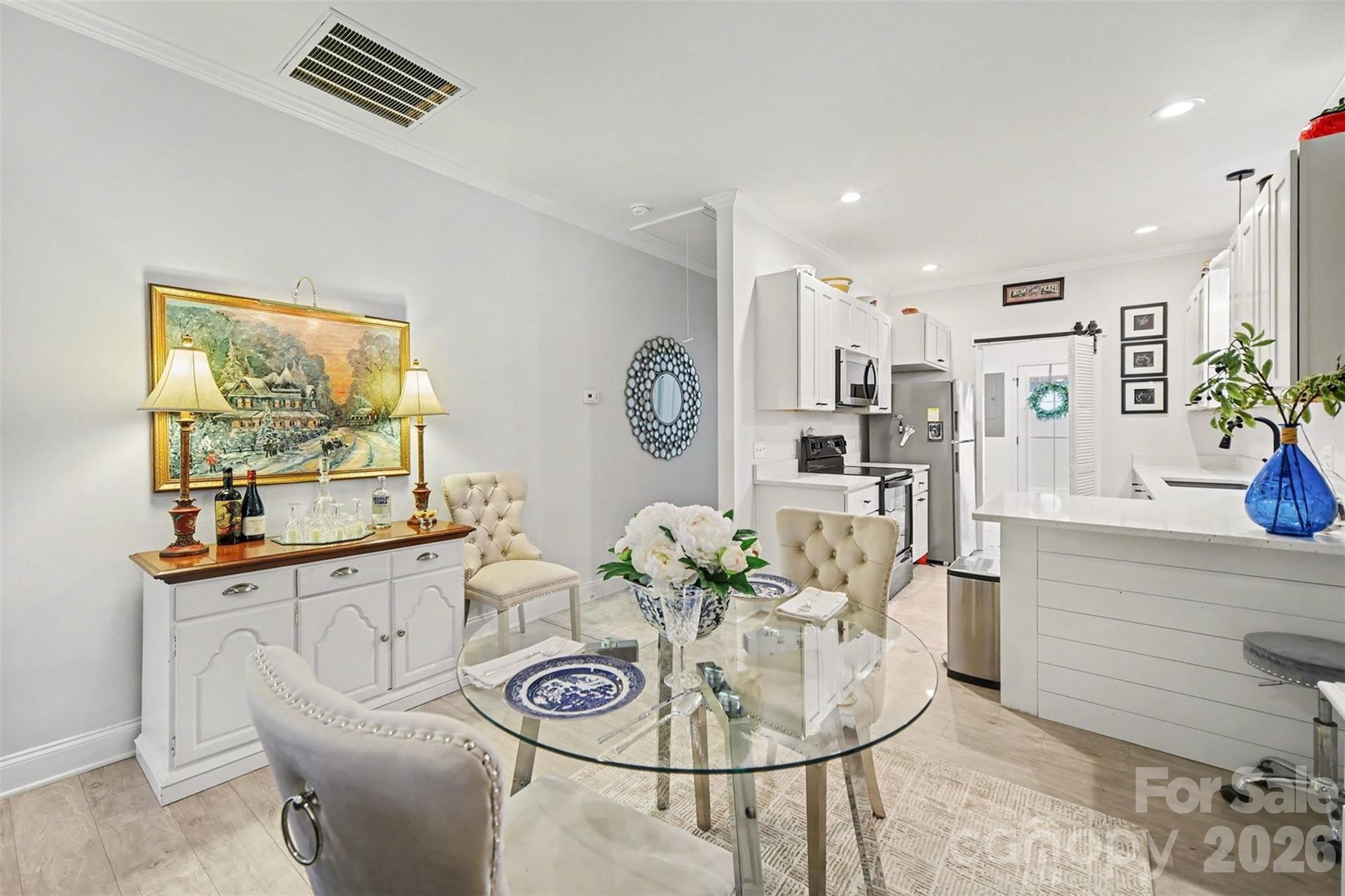 3236 Cottage Rose Lane Rock Hill, SC 29732 - Photo 4 of 27 a living room with furniture a chandelier and a dining table