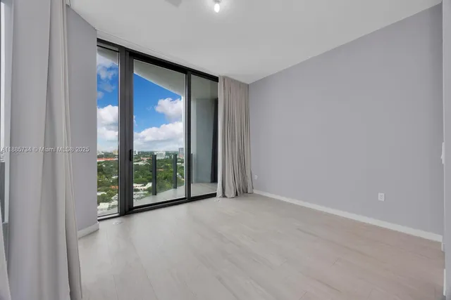 a bedroom with a large bed and a large window