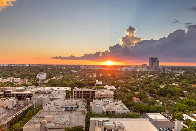 a view of a bedroom with a bed and large windows