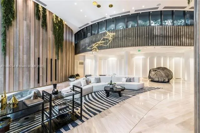 a living room with furniture and large windows